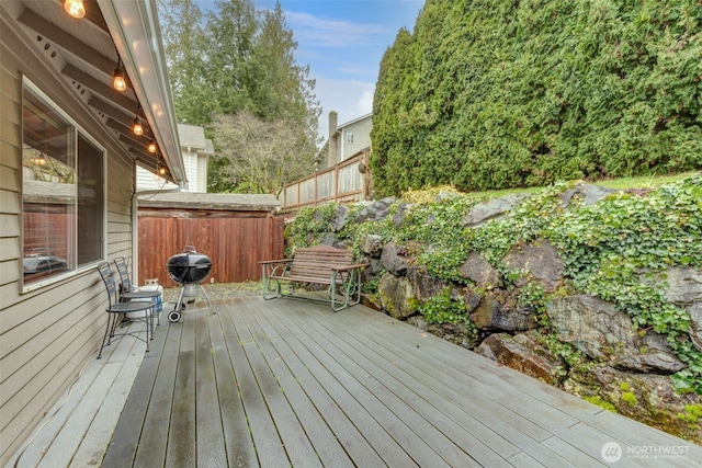 wooden terrace featuring fence