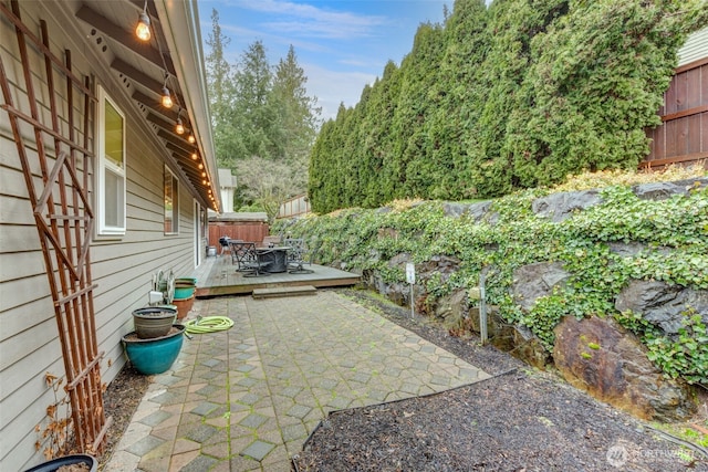 view of patio with fence and a deck