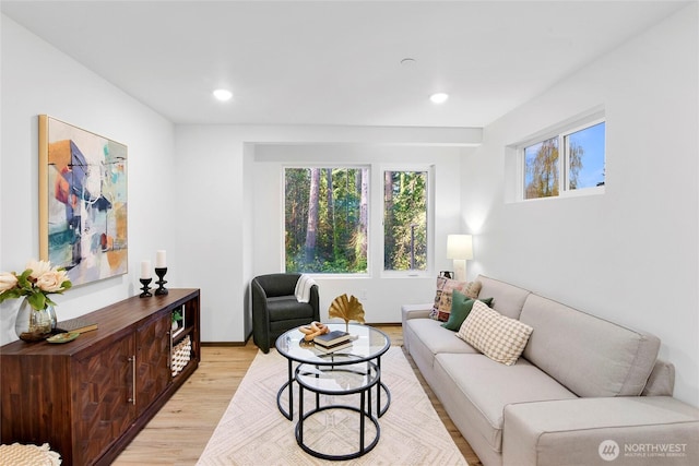 living room featuring plenty of natural light, light wood-type flooring, and recessed lighting