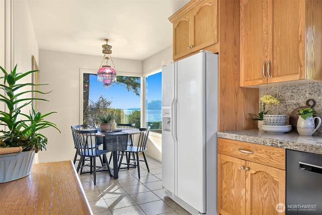 kitchen with light tile patterned floors, white refrigerator with ice dispenser, decorative backsplash, dishwasher, and pendant lighting