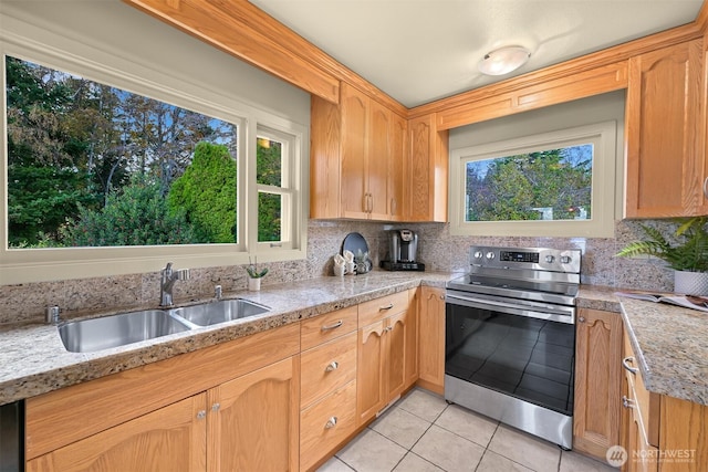 kitchen with a sink, backsplash, electric stove, and light tile patterned flooring
