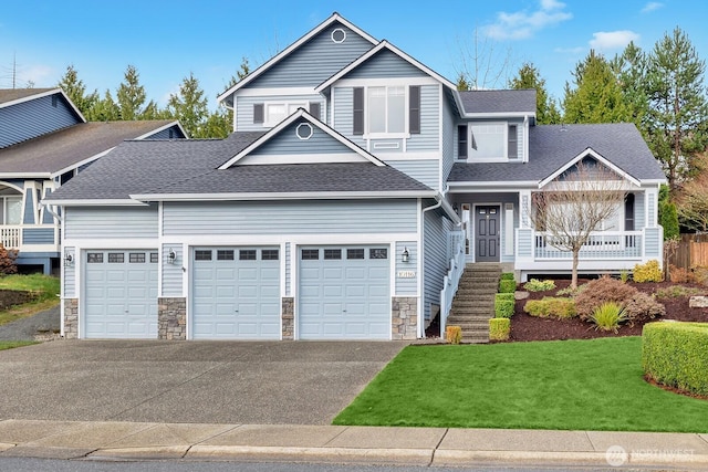 view of front of house with stone siding, driveway, and roof with shingles