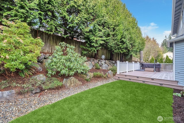 view of yard with a deck and fence