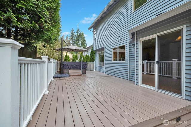 deck featuring a hot tub