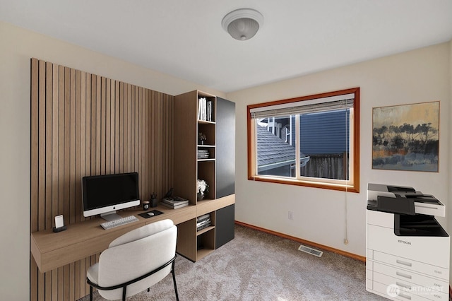 carpeted office with visible vents and baseboards