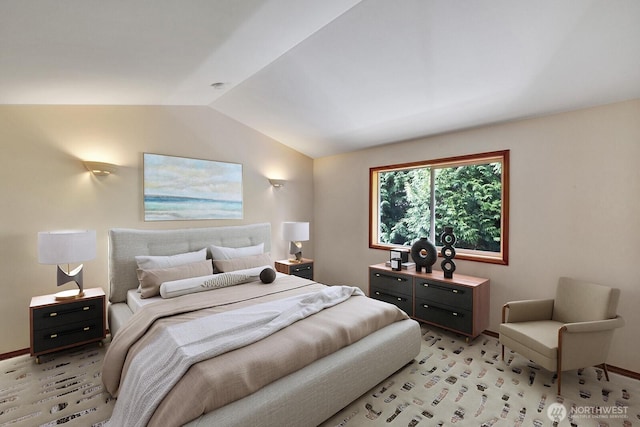 bedroom with light colored carpet, baseboards, and lofted ceiling