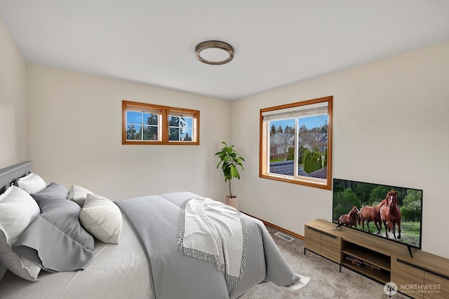 bedroom featuring carpet flooring and baseboards