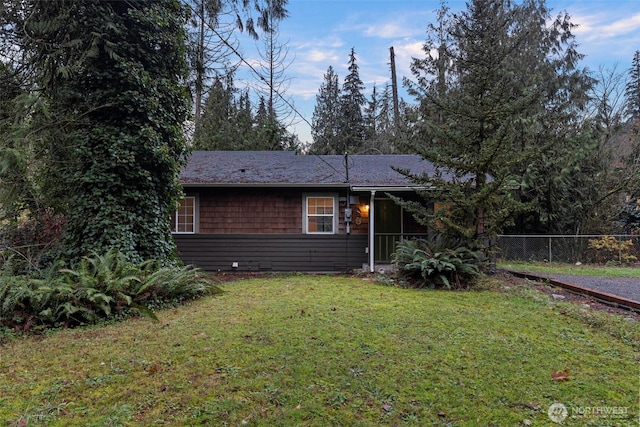 view of front of house with a front lawn and fence