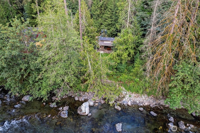 drone / aerial view featuring a forest view