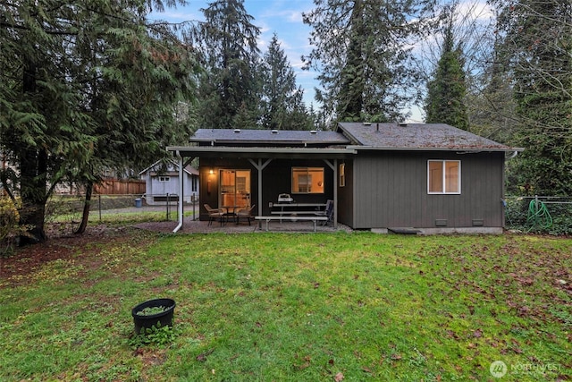 back of house with crawl space, a yard, fence, and a patio