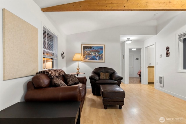 living room with lofted ceiling with beams, baseboards, and wood finished floors