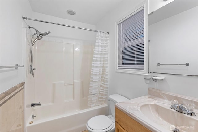 bathroom with shower / tub combo, vanity, and toilet