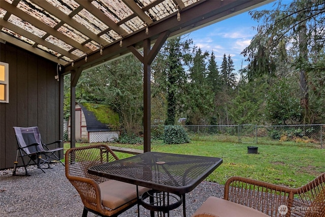 view of patio featuring an outbuilding, a fenced backyard, a storage shed, and a pergola