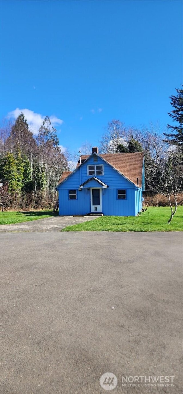 view of side of home featuring a yard