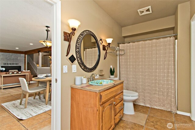 bathroom with toilet, visible vents, vanity, a shower with curtain, and tile patterned floors