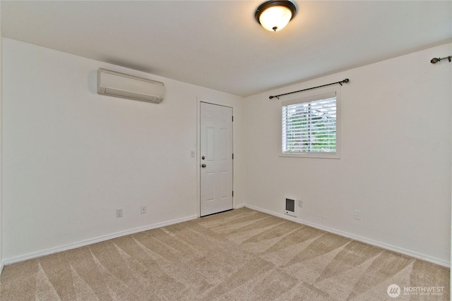 unfurnished room with a wall unit AC, visible vents, light carpet, and baseboards