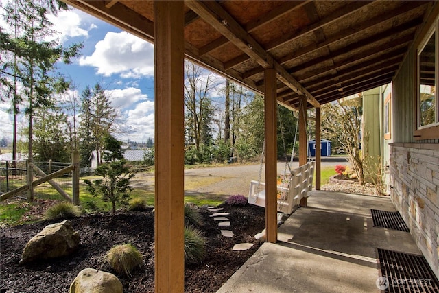 view of patio with an outdoor structure and fence