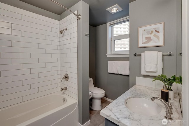 full bath with toilet, bathtub / shower combination, baseboards, and vanity