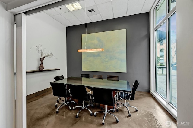 office with concrete flooring, visible vents, and baseboards