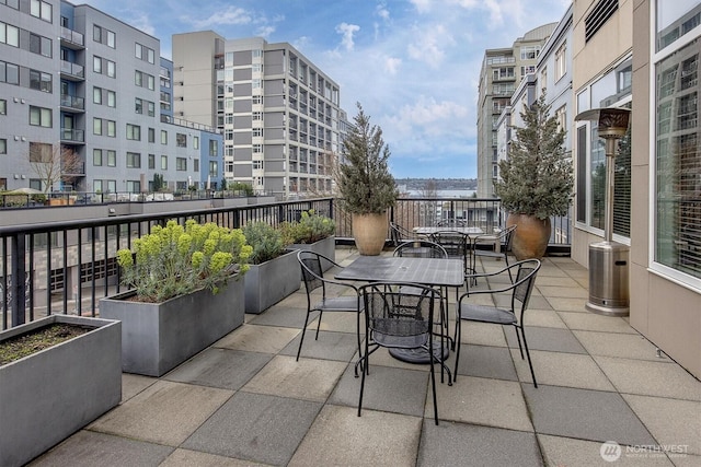 balcony with a patio area and outdoor dining area