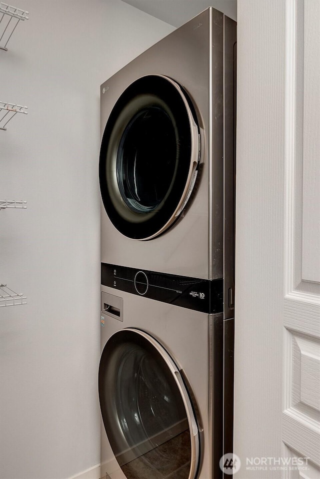 clothes washing area with laundry area and stacked washer / dryer