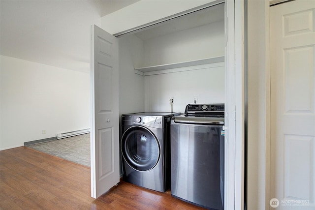 washroom with a baseboard radiator, dark wood finished floors, independent washer and dryer, and laundry area