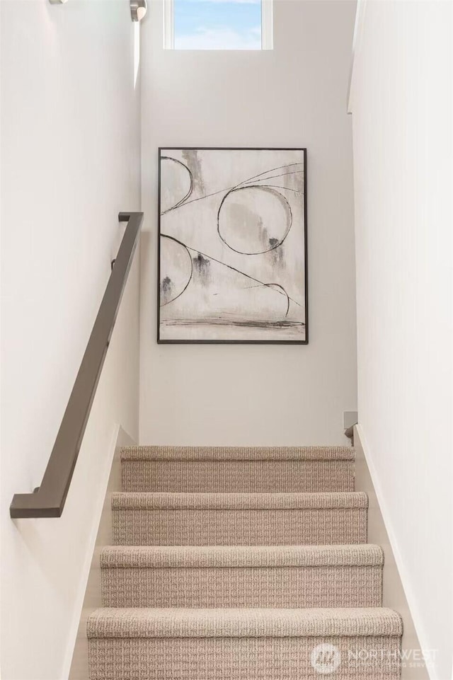 stairway featuring baseboards