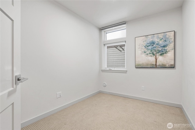 carpeted spare room with baseboards