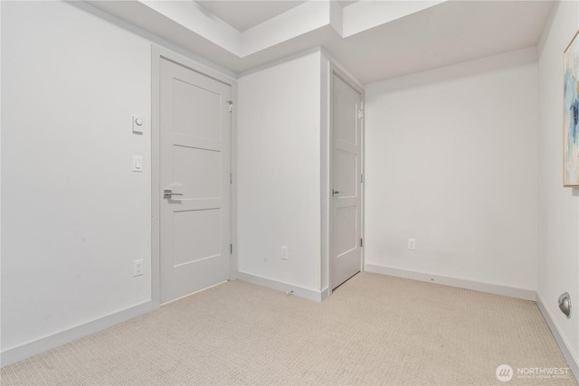 carpeted spare room with baseboards