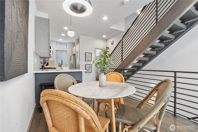 dining area featuring recessed lighting, stairway, and wood finished floors