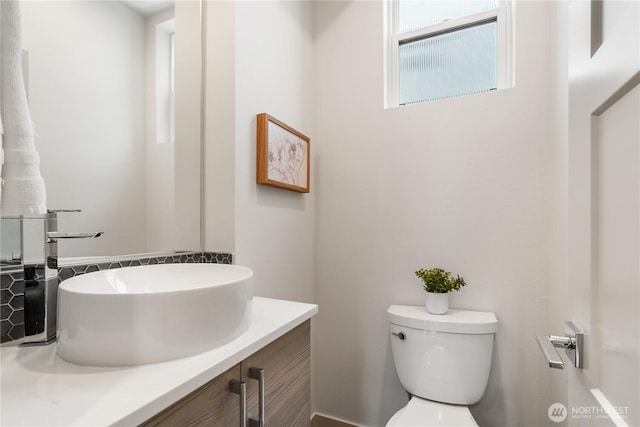 half bath featuring toilet and vanity