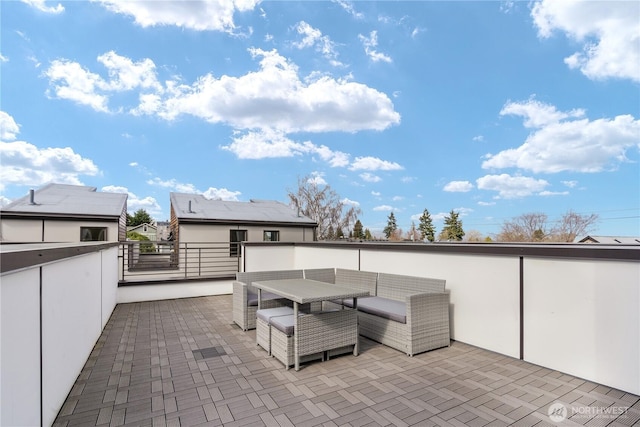 view of patio with an outdoor living space and a balcony