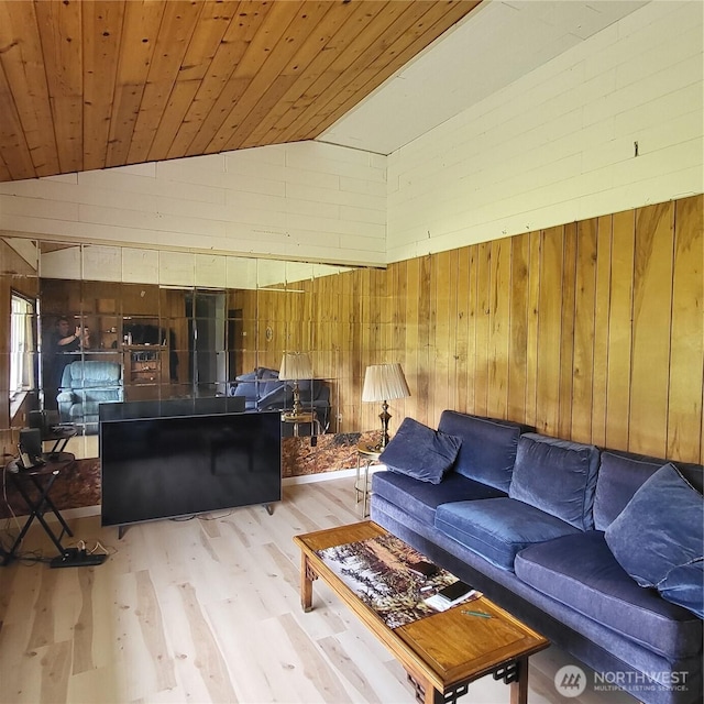 living room with lofted ceiling, wooden ceiling, wood walls, and wood finished floors