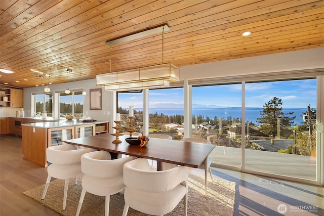 dining area featuring recessed lighting, wooden ceiling, light wood finished floors, and wine cooler