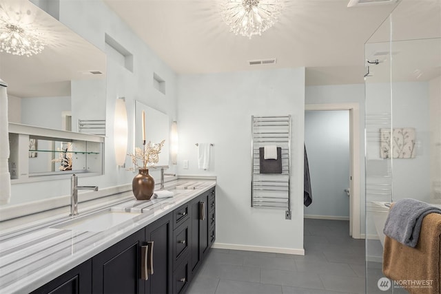 bathroom with double vanity, a sink, visible vents, and a notable chandelier