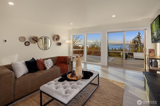 living area with light tile patterned flooring and recessed lighting