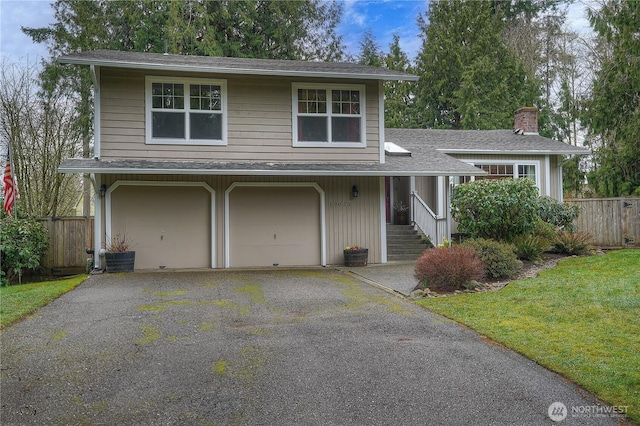 view of front of home with roof with shingles, a chimney, fence, a garage, and driveway