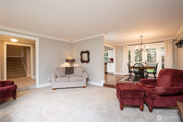 carpeted living room with an inviting chandelier, stairs, baseboards, and crown molding