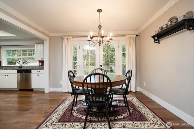 dining room featuring crown molding, dark wood finished floors, and baseboards