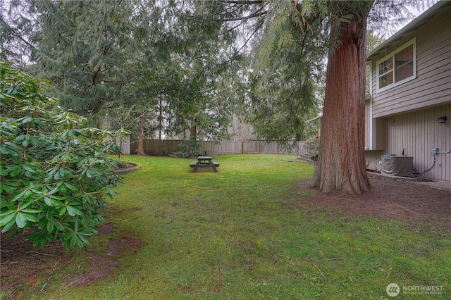 view of yard featuring cooling unit and fence