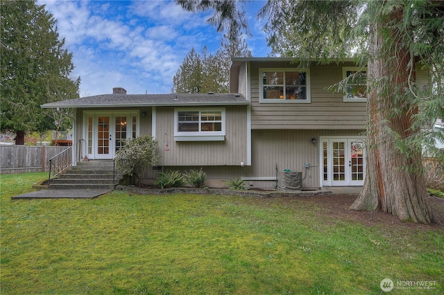 tri-level home featuring central AC, french doors, a front lawn, and fence