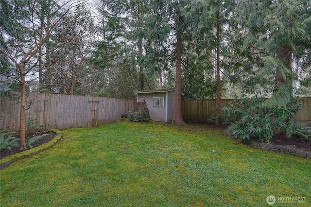 view of yard with a storage shed, a fenced backyard, and an outdoor structure