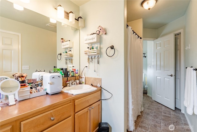 full bath featuring vanity and a shower with shower curtain