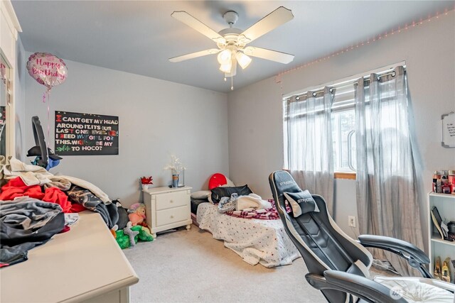 bedroom featuring ceiling fan and light carpet