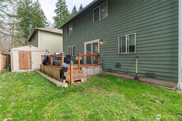 back of house featuring a lawn, a deck, a shed, an outdoor structure, and crawl space