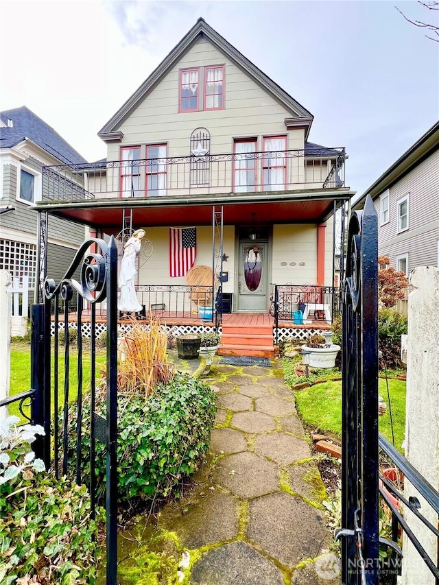 view of front of home featuring covered porch and a balcony