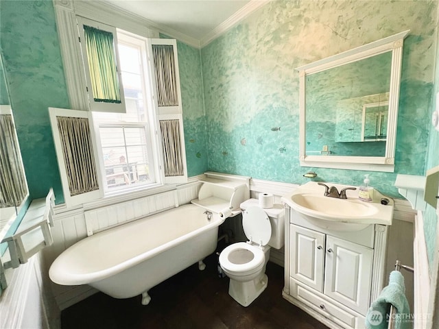 bathroom featuring a soaking tub, plenty of natural light, toilet, and wallpapered walls