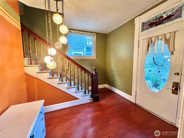 entrance foyer with stairs, baseboards, and wood finished floors