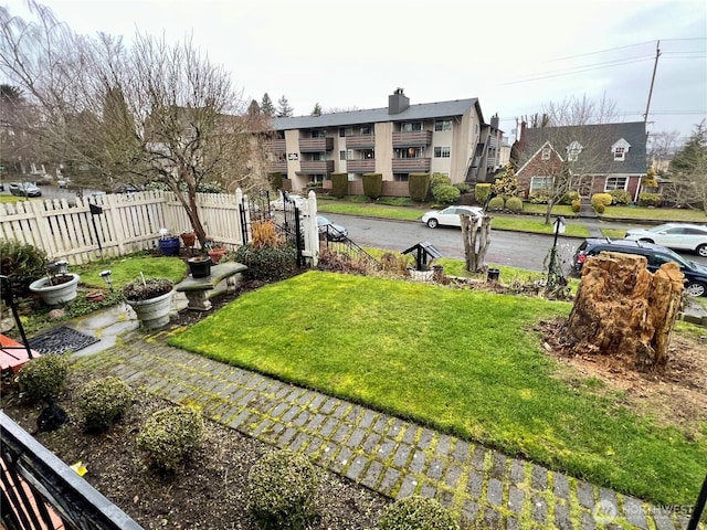 view of yard with fence and a residential view