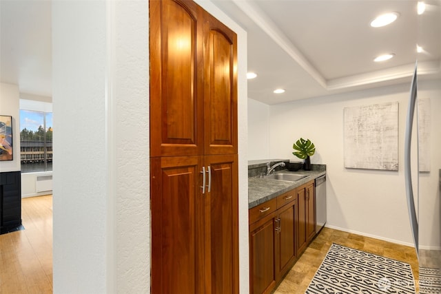 bar featuring dishwasher, baseboards, a sink, and recessed lighting